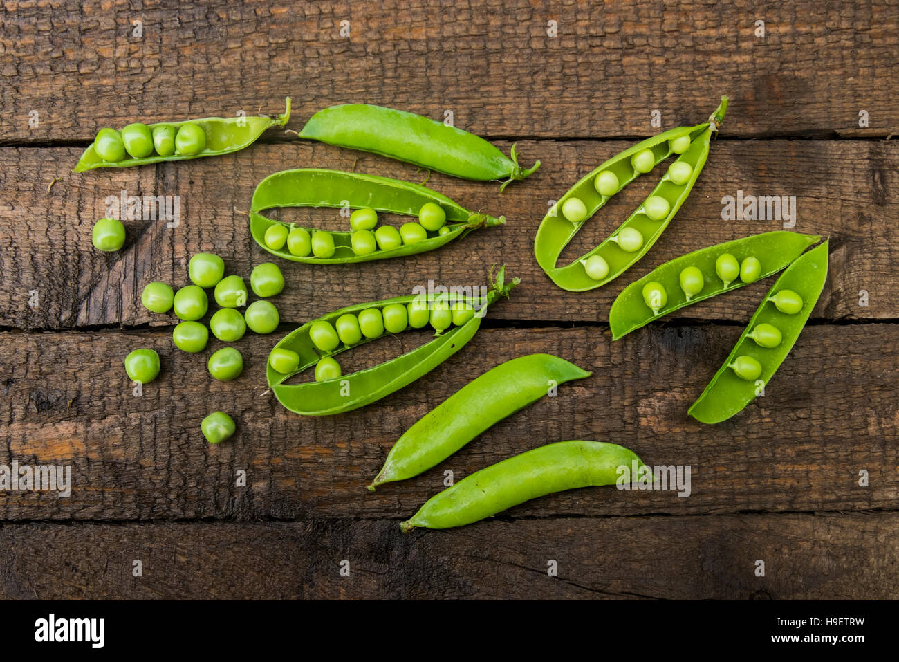 Fresh peas on wooden table Stock Photo