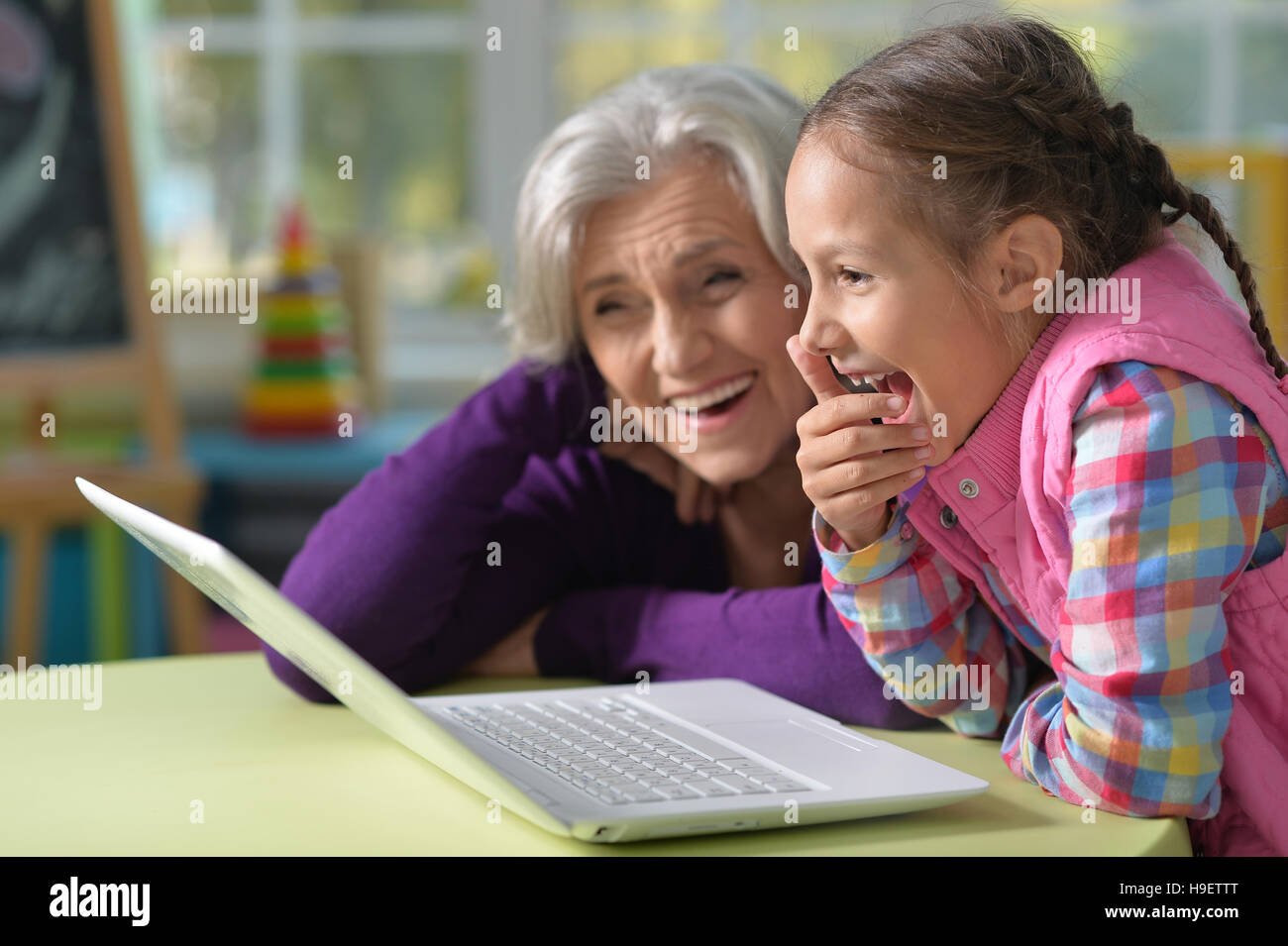 Grandmother and granddaughter with laptop Stock Photo - Alamy