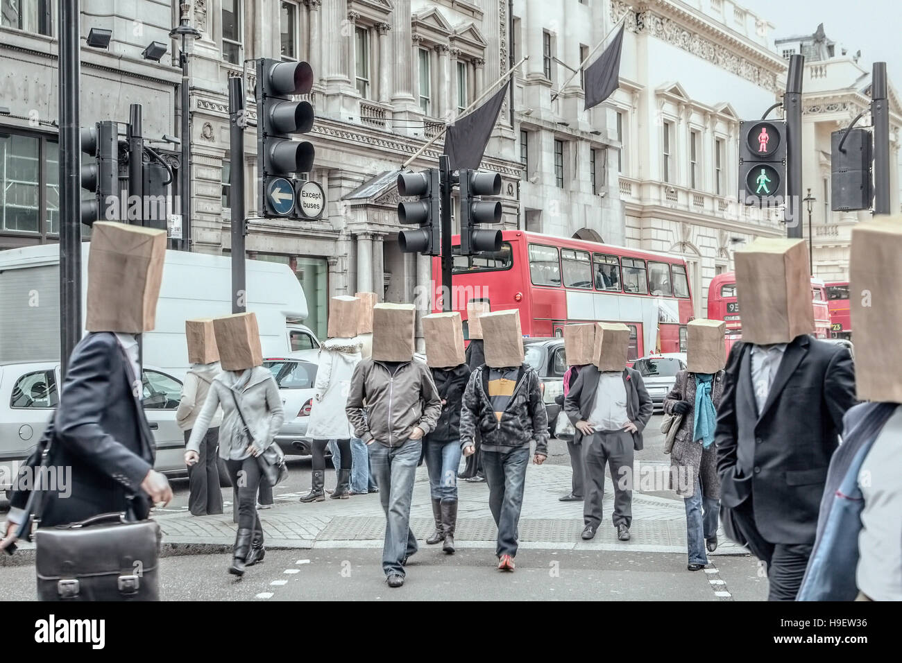 Anonymous people wearing paper bags on head in city Stock Photo