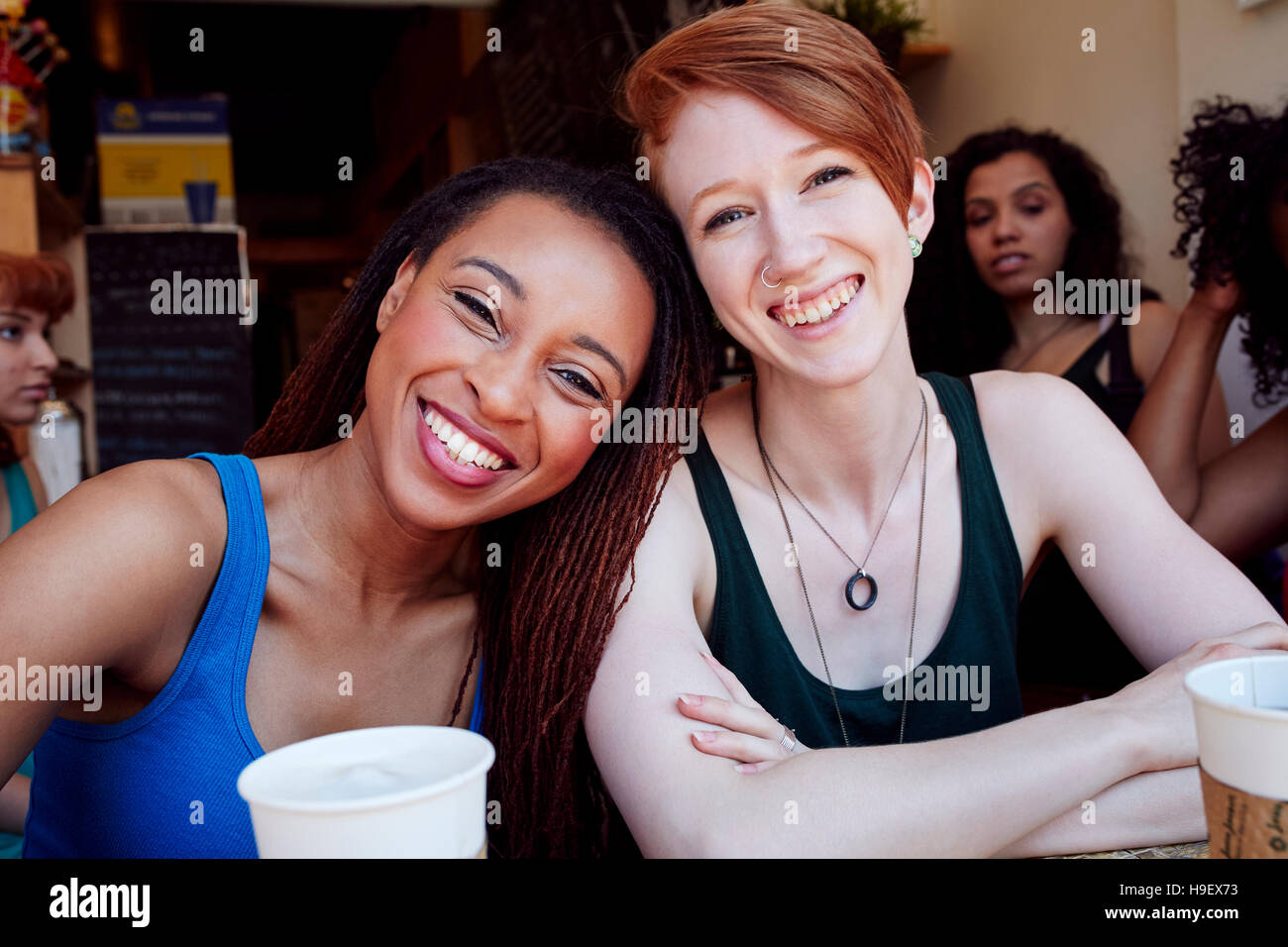 Smiling women in coffee shop Stock Photo