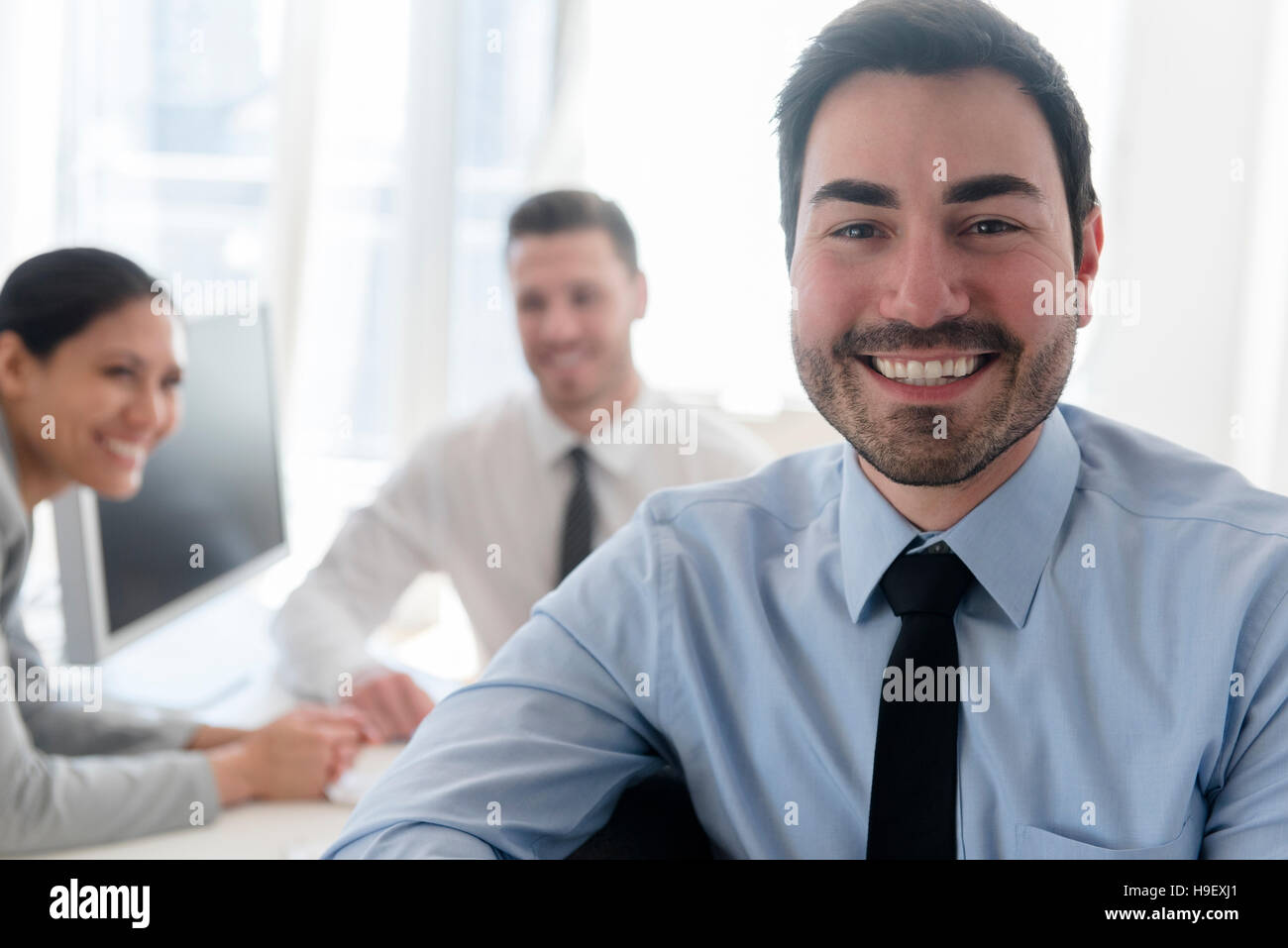 Portrait of smiling businessman in office Stock Photo - Alamy