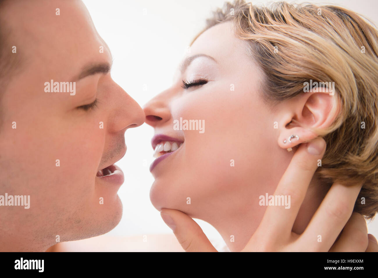 Caucasian couple kissing Stock Photo