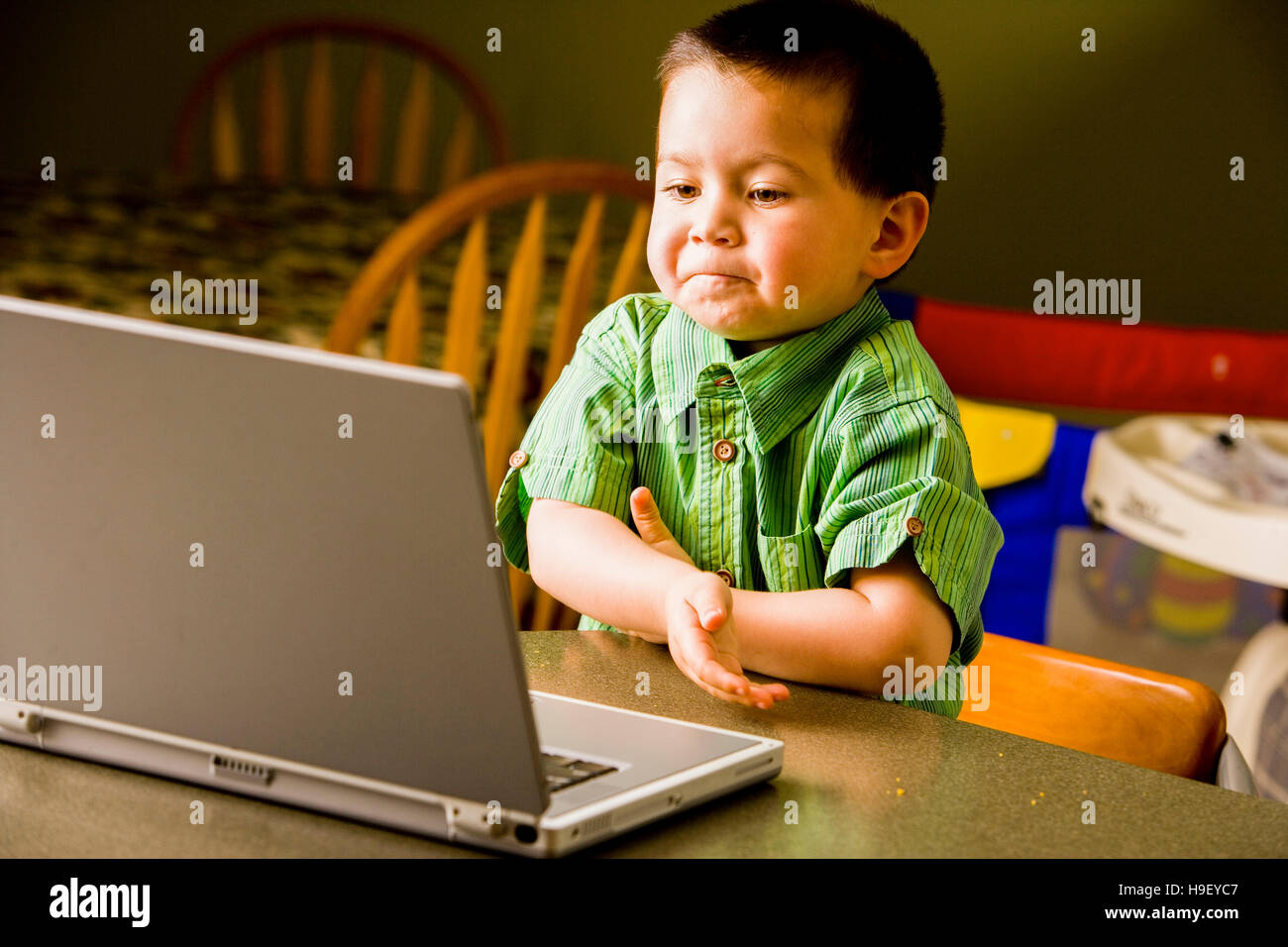 Mixed Race boy using laptop Stock Photo