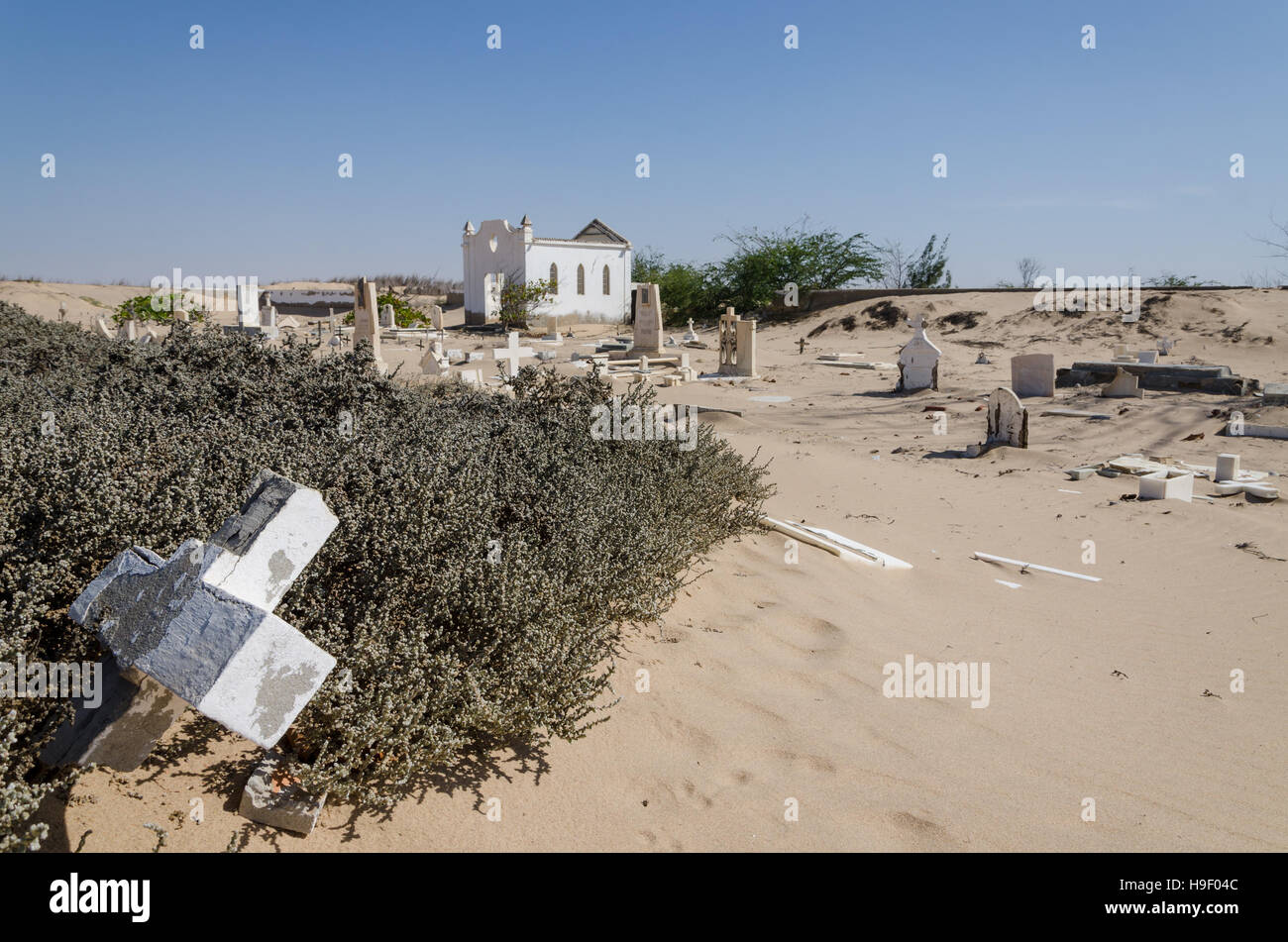 Abandoned graveyard with crumbling stones and crosses in Namib Desert of Angola Stock Photo