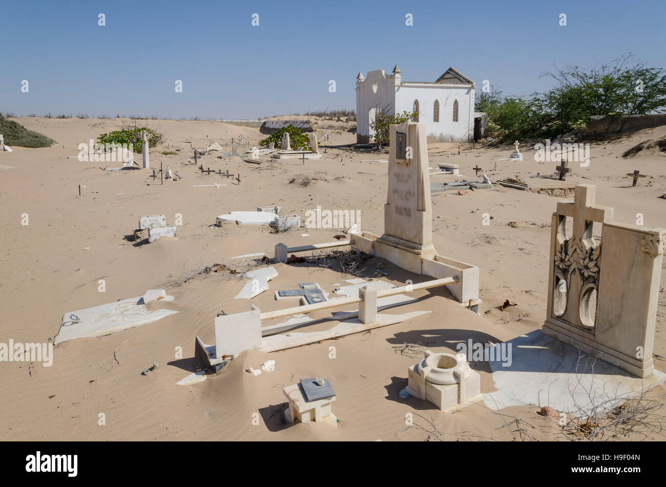 Abandoned graveyard with crumbling stones and crosses in Namib Desert of Angola Stock Photo