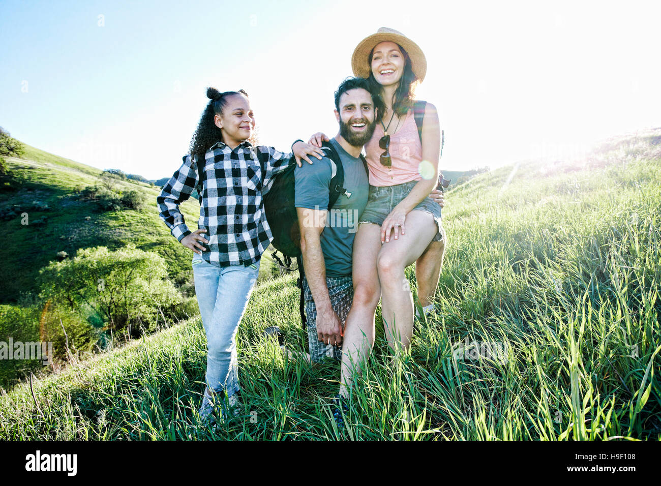 Portrait of smiling family posing on hill Stock Photo