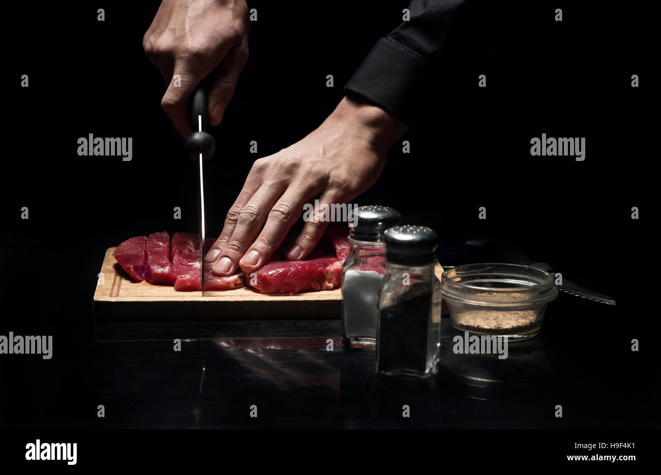 Close up of chefs hands chopping meat Stock Photo