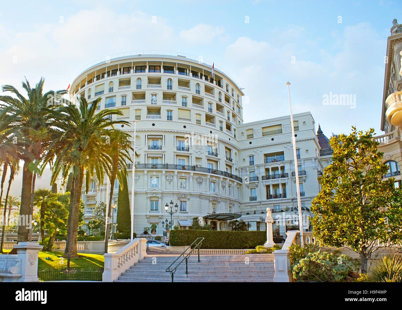 The walk along the shady streets of Monte Carlo with the view on the side facade of luxury Hotel de Paris, Monaco. Stock Photo