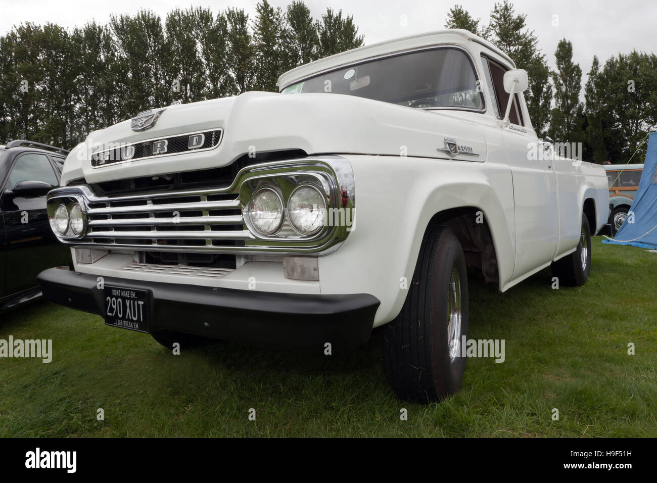 Three-quarter view of a white 1959, Ford F-100 Pick-up truck on display at the 2016 Silverstone Classic. Stock Photo