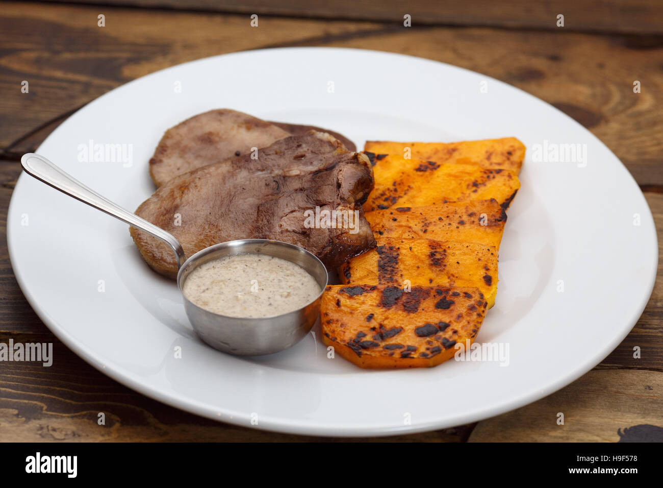 Meat tongue with sauce and pumpkin Stock Photo Alamy