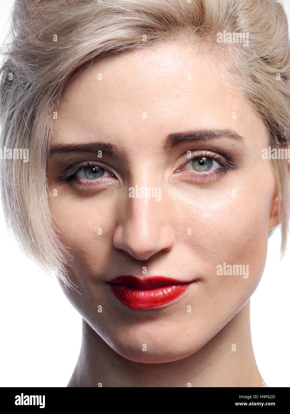 A head shot of a blond female model on a white background. Stock Photo