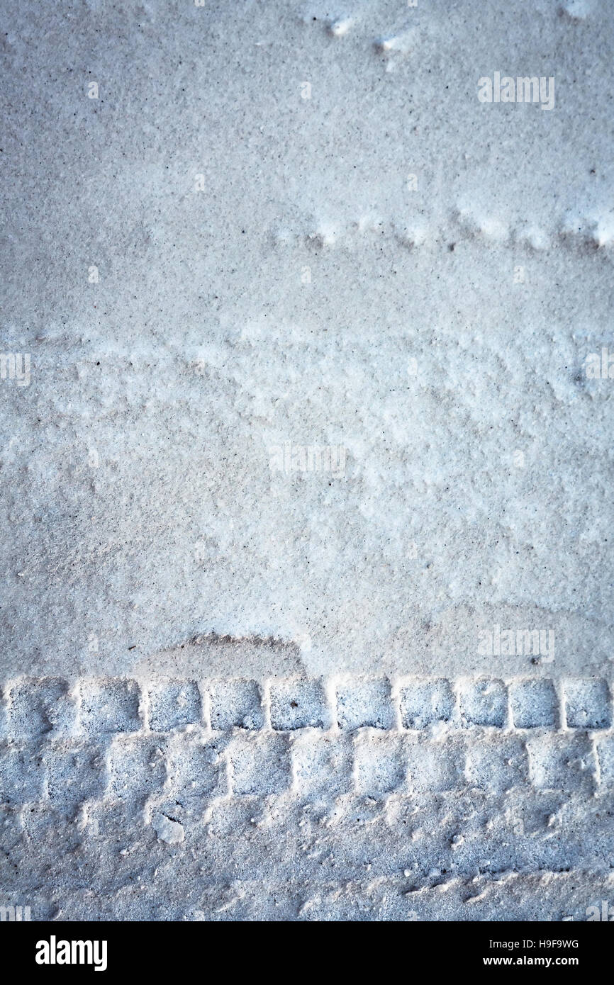Winter driving with tire trace on snow background Stock Photo - Alamy