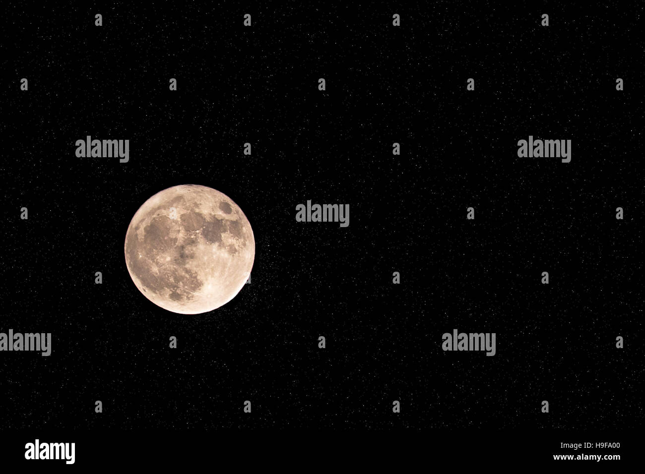 Big moon surrounded by millions of bright stars. Stock Photo