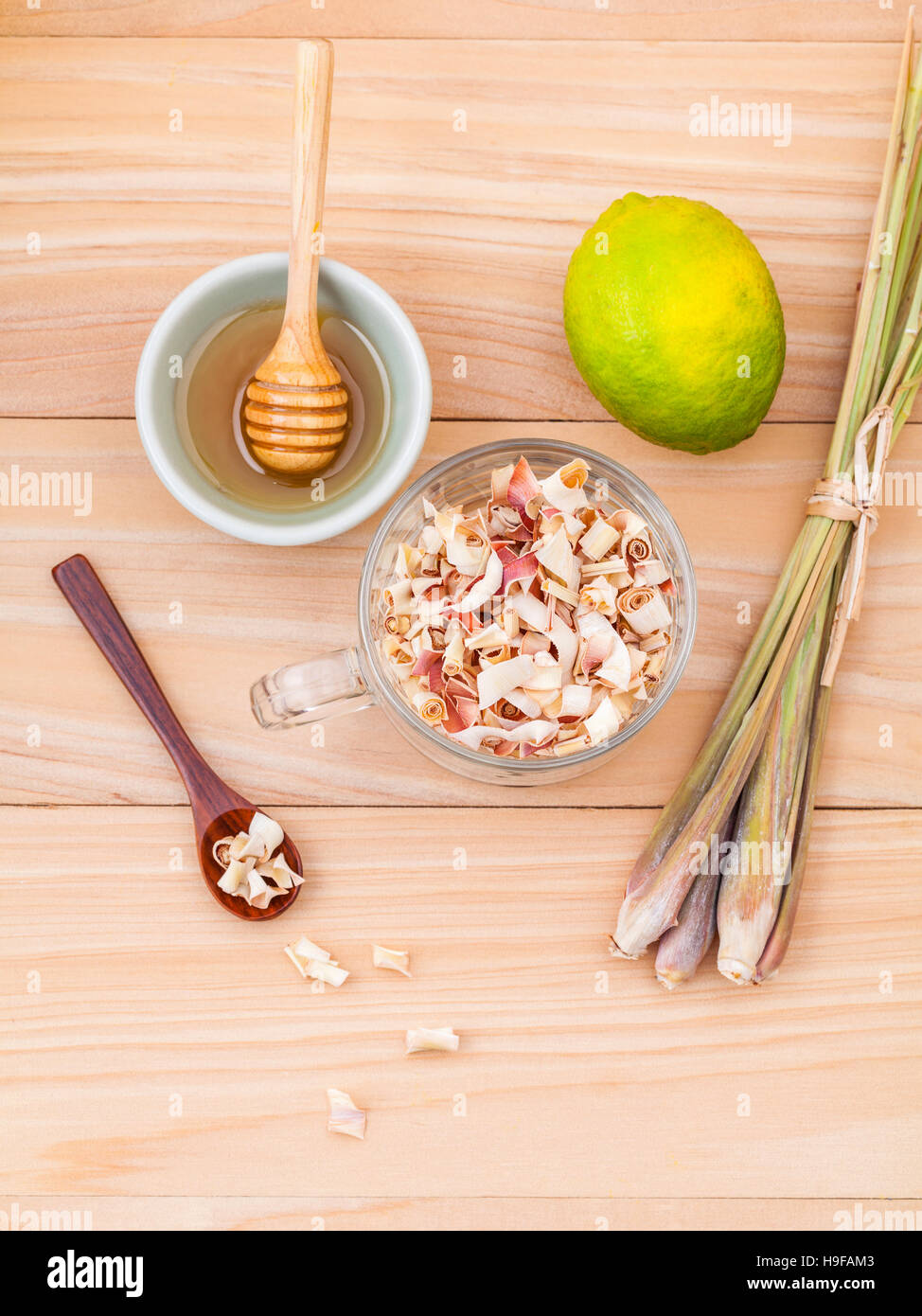 Cup of herbal tea with dried lemon grass ,honey and lemon on woo Stock