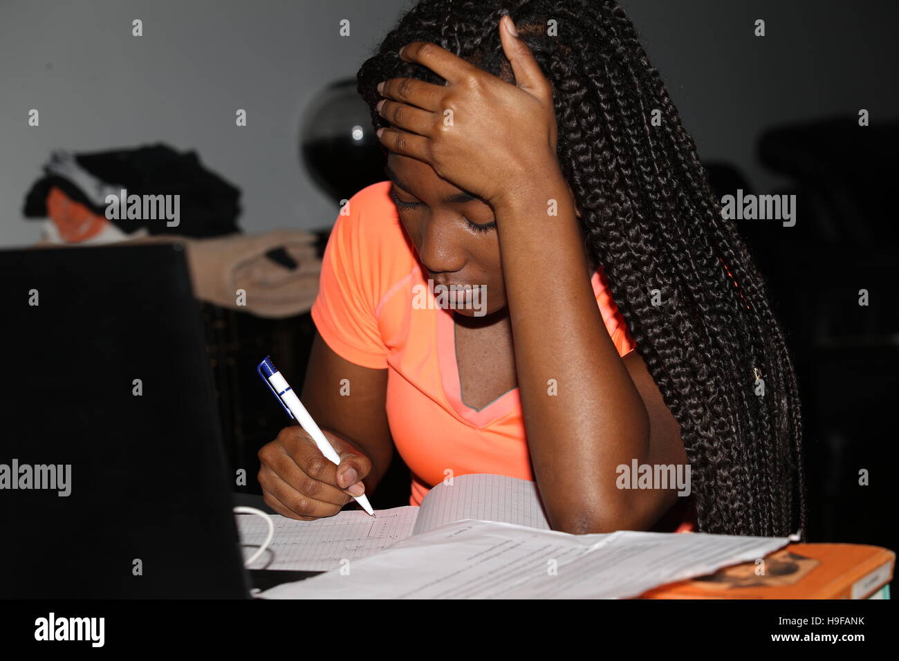Black teenage girl doing homework Stock Photo