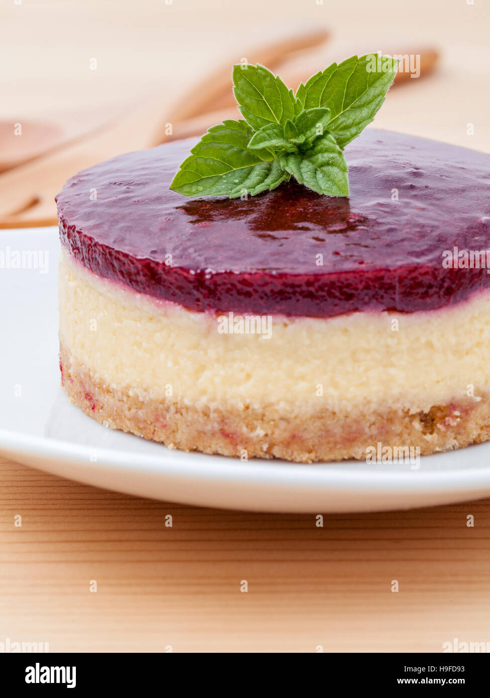 Blueberry cheesecake with fresh mint leaves on wooden background Stock Photo