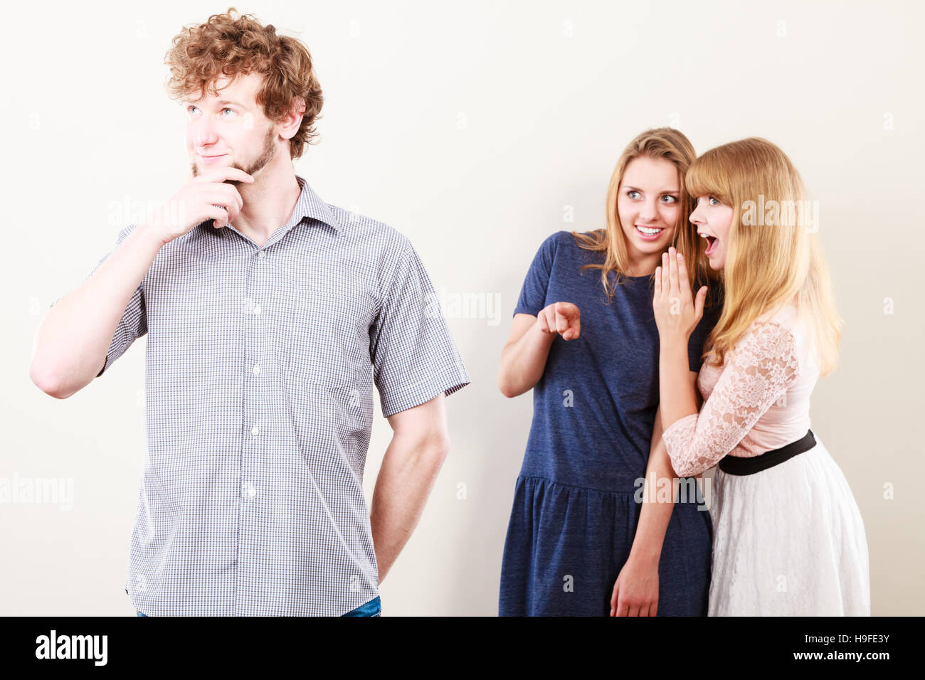 Young women friends talking gossiping about man. Two women whispering  sharing secret news Stock Photo - Alamy