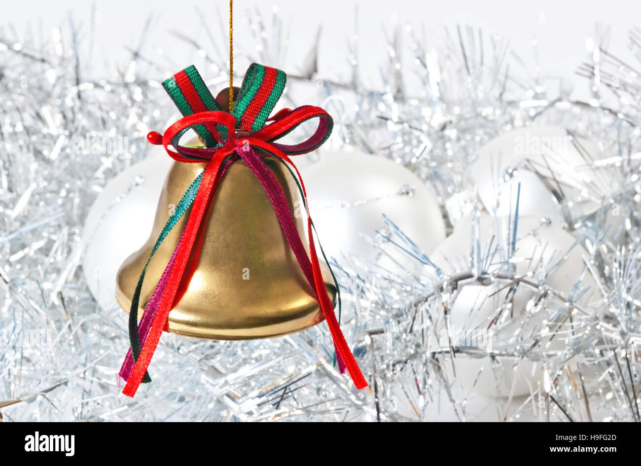 Golden Christmas bell on the white unfocused background Stock Photo - Alamy