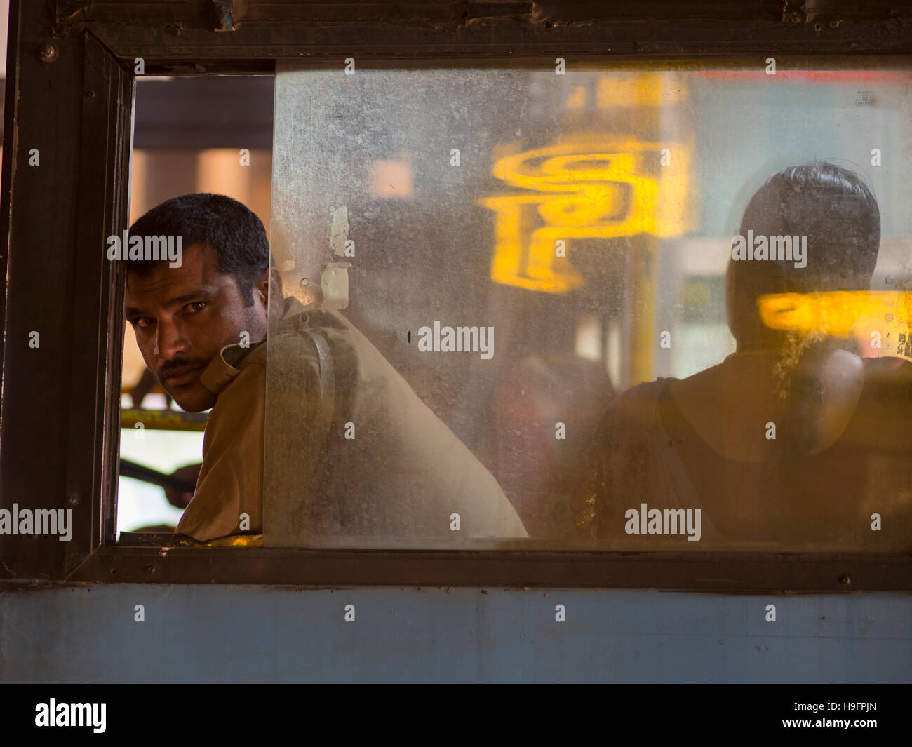Bus conductor and woman at bus in Bangalore, Karnataka, India Stock Photo