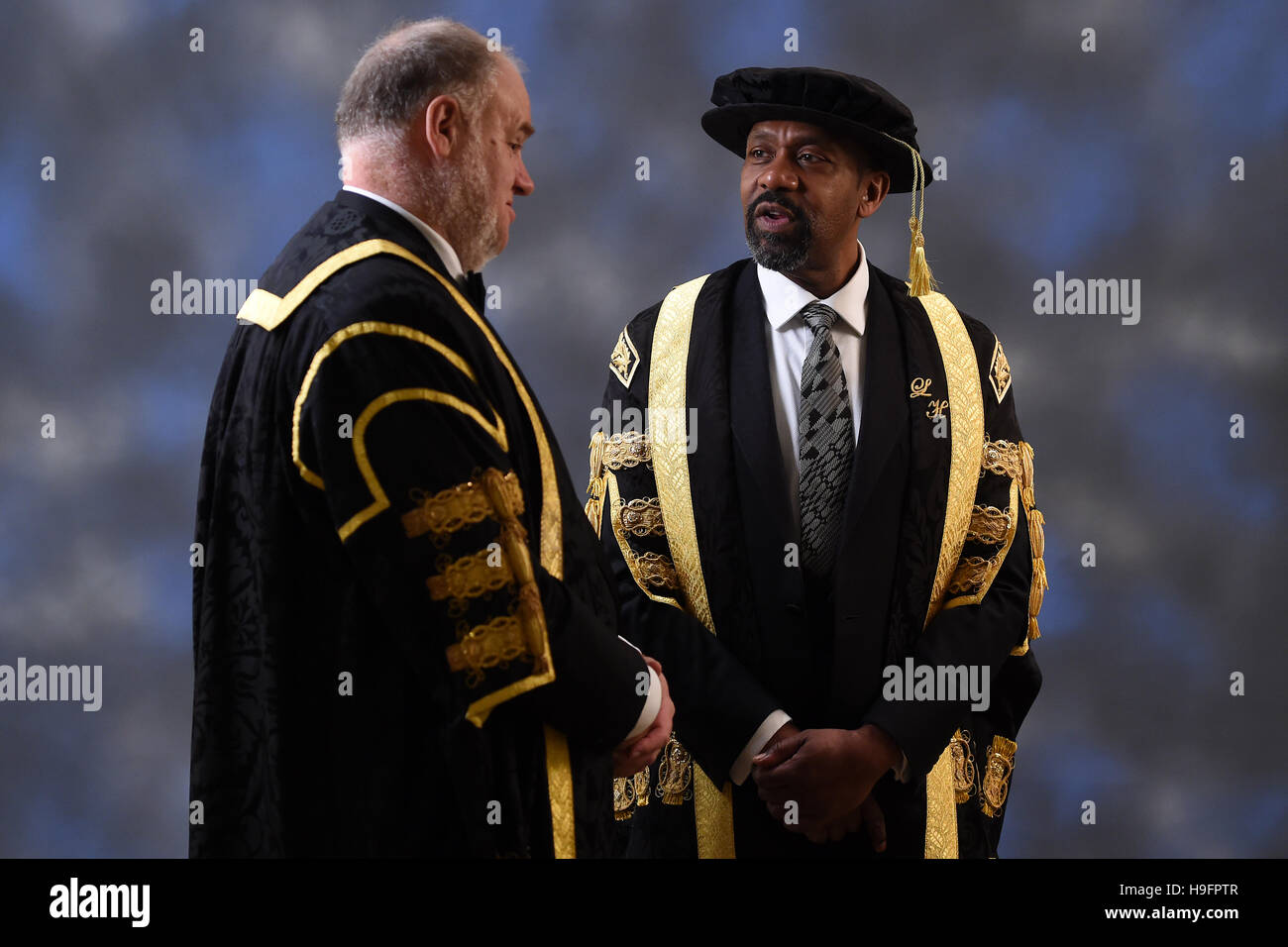 Sir Lenny Henry talks to Pro-Chancellor and Chairman of the Board of Governors Mark Hopton (left) as he formally accepts his role as Chancellor of Birmingham City University during the installation ceremony at Birmingham Town Hall. Stock Photo