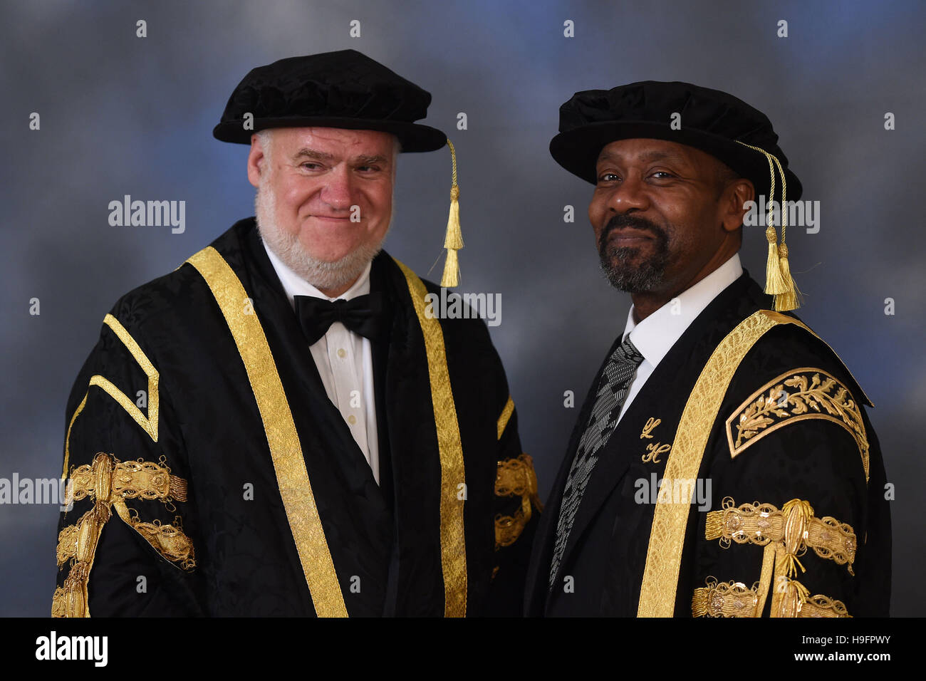 Sir Lenny Henry wears his new ceremonial robes for the first time alongside Pro-Chancellor and Chairman of the Board of Governors Mark Hopton (left) as he formally accepts his role as Chancellor of Birmingham City University during the installation ceremony at Birmingham Town Hall. Stock Photo