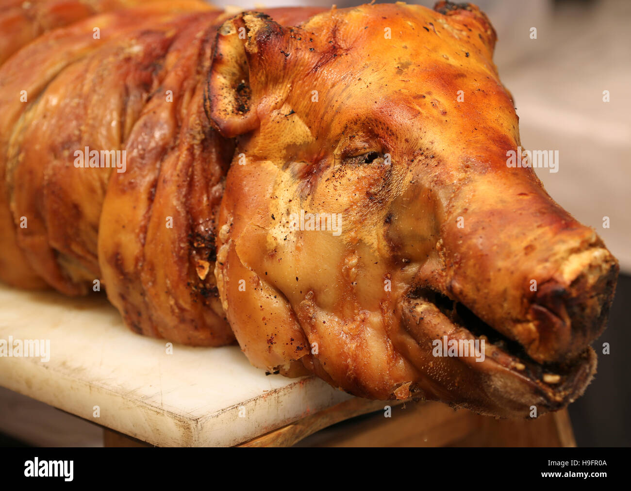 Portrait of the roasted pig on a spit in the butcher Stock Photo