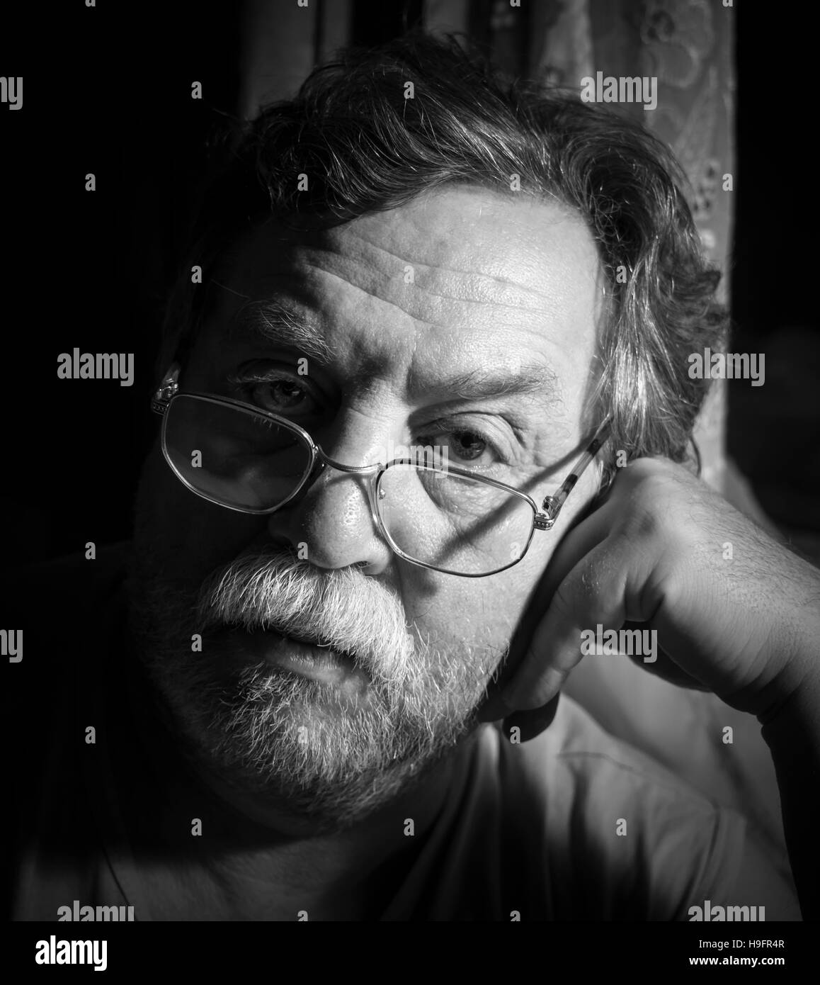 Black and white monochrome photo. Portrait of a sad adult man with a gray mustache. 'Real People' series Stock Photo