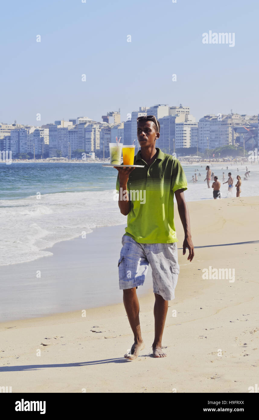 Brazil, City of Rio de Janeiro, Man selling caipirinhas on Copacabana Beach. Stock Photo