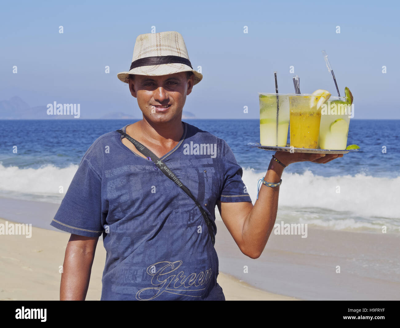 Brazil, City of Rio de Janeiro, Man selling caipirinhas on Copacabana Beach. Stock Photo