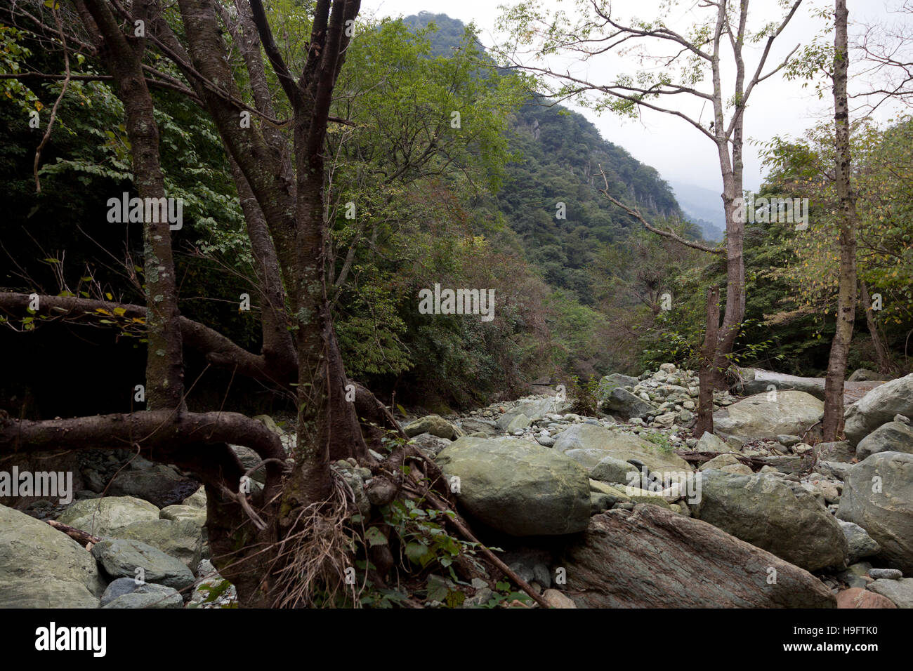 The river in the upper reaches of the valley at Bai Shui Jiang almost dries out in the dry wintery season. Stock Photo