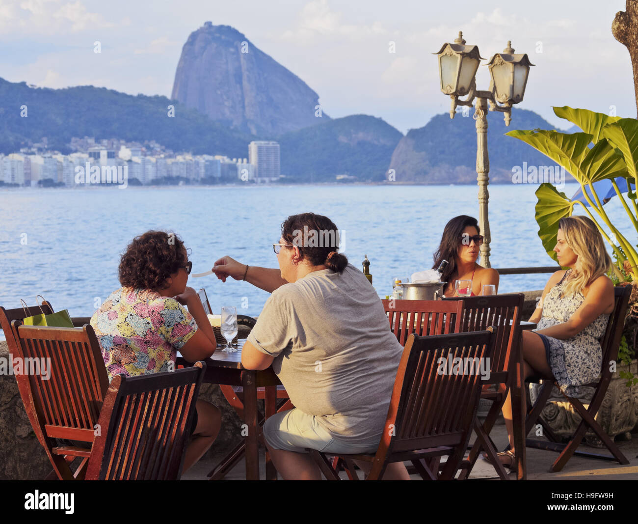 Brazil, City of Rio de Janeiro, Copacabana, Cafe in the Fort Copacabana with the view of Sugarloaf Mountain. Stock Photo