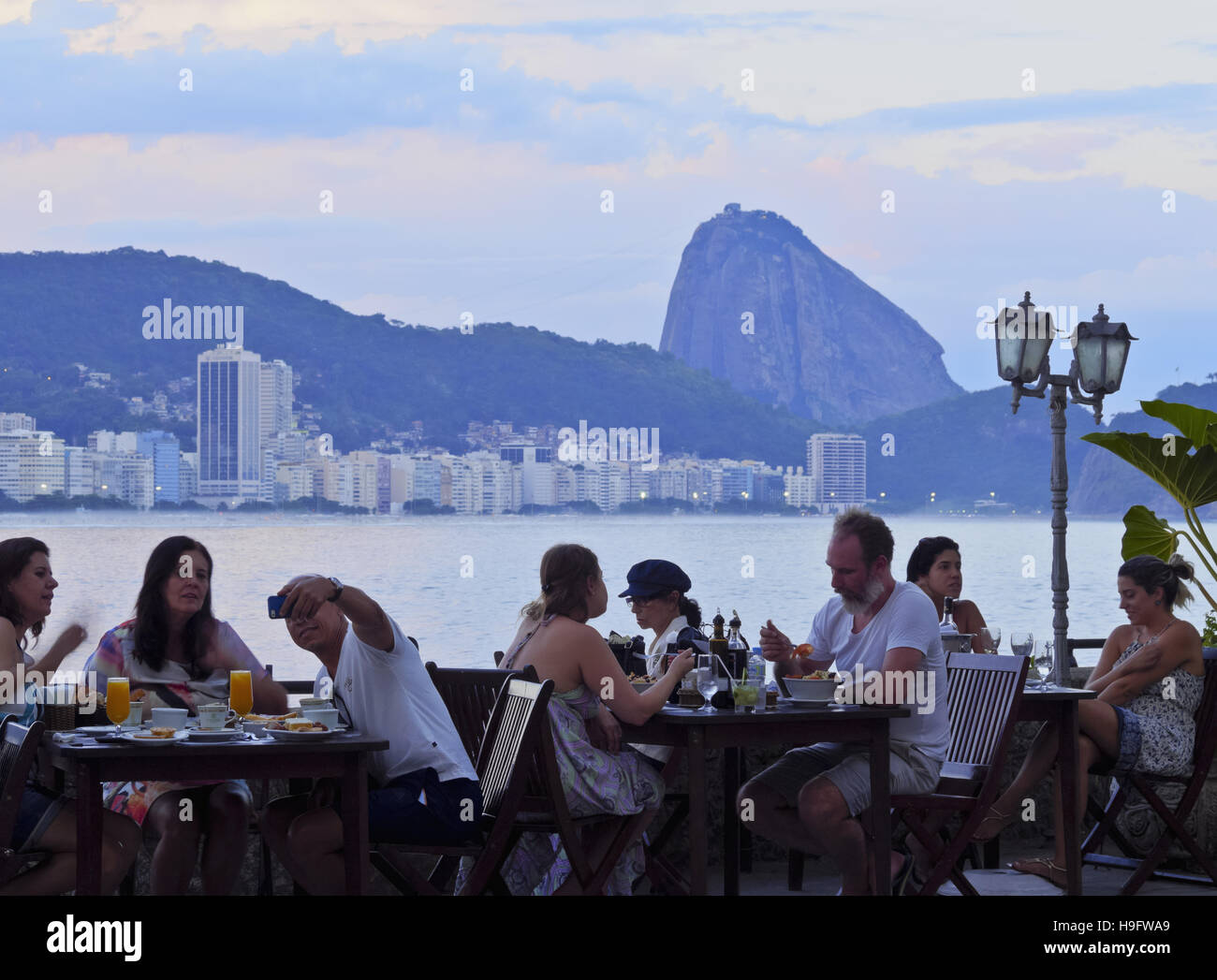 Brazil, City of Rio de Janeiro, Copacabana, Cafe in the Fort Copacabana with the view of Sugarloaf Mountain. Stock Photo