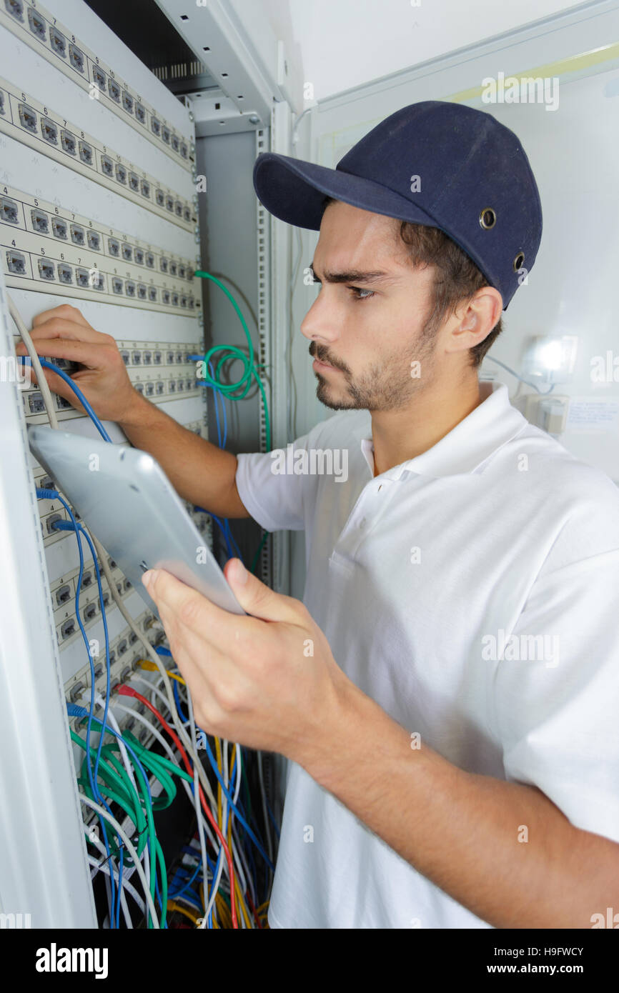 focused electrician applying safety procedure while working on