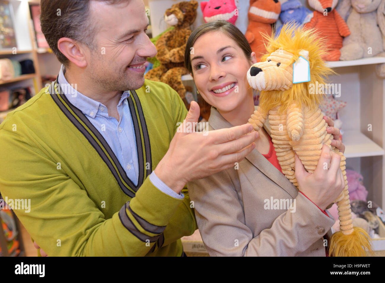 parents-to-be shopping choosing plush for their kid Stock Photo