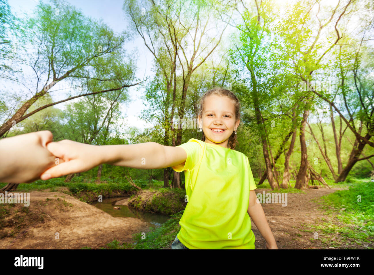Portrait of smiling girl having fun in the forest Stock Photo - Alamy