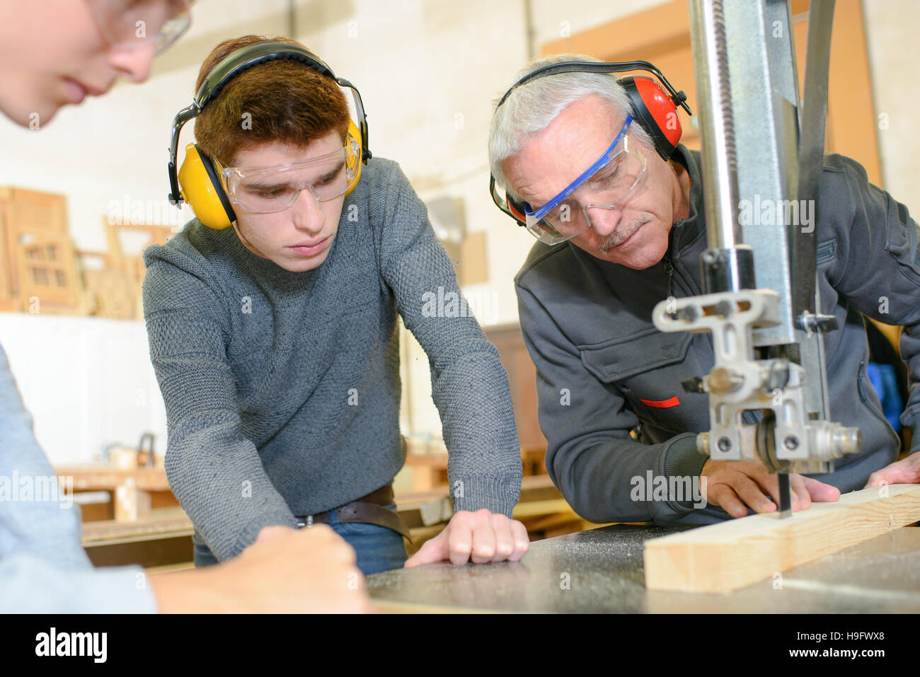 teacher showing students how to use sewing machine Stock Photo Alamy