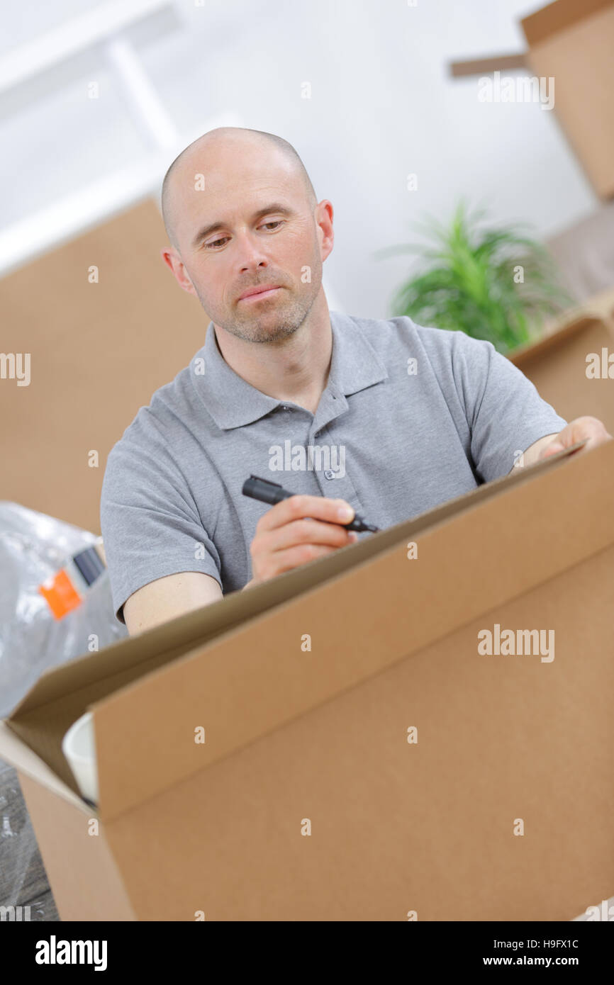 man writing with marker on box Stock Photo - Alamy