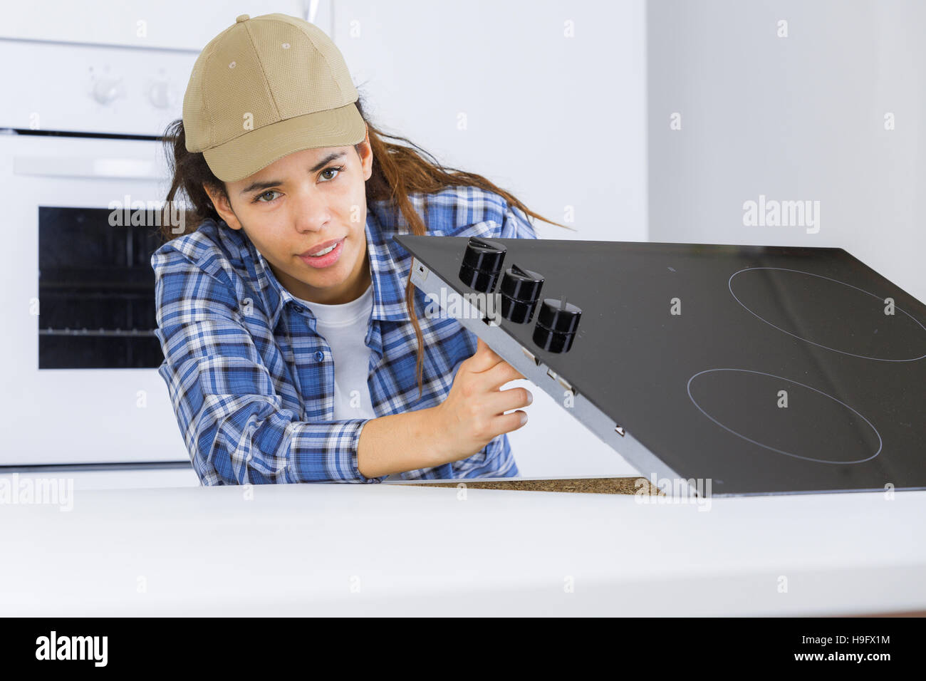 young woman repairing induction hob Stock Photo Alamy