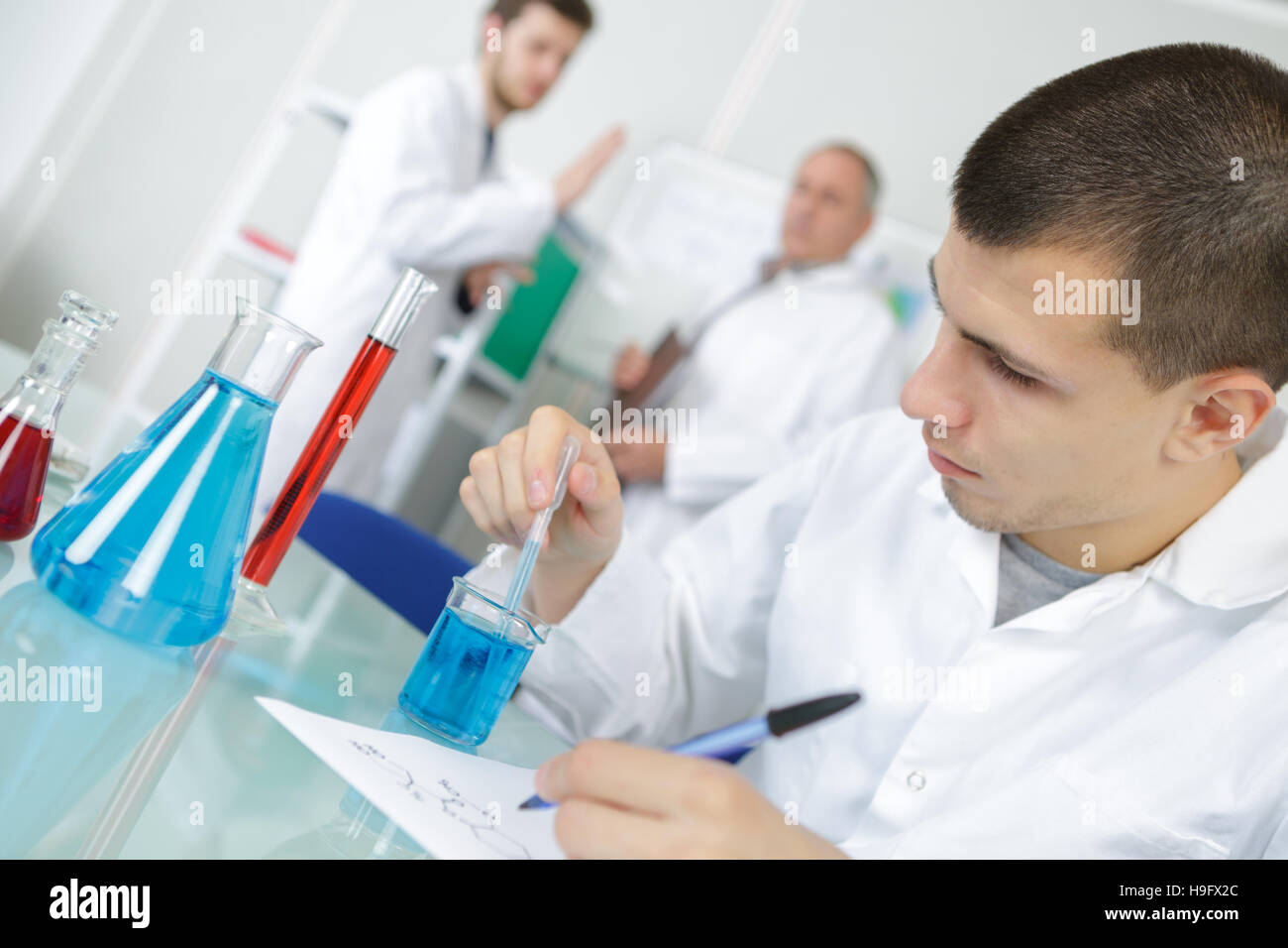 professionals pipetting master mix solution using multi channel pipette