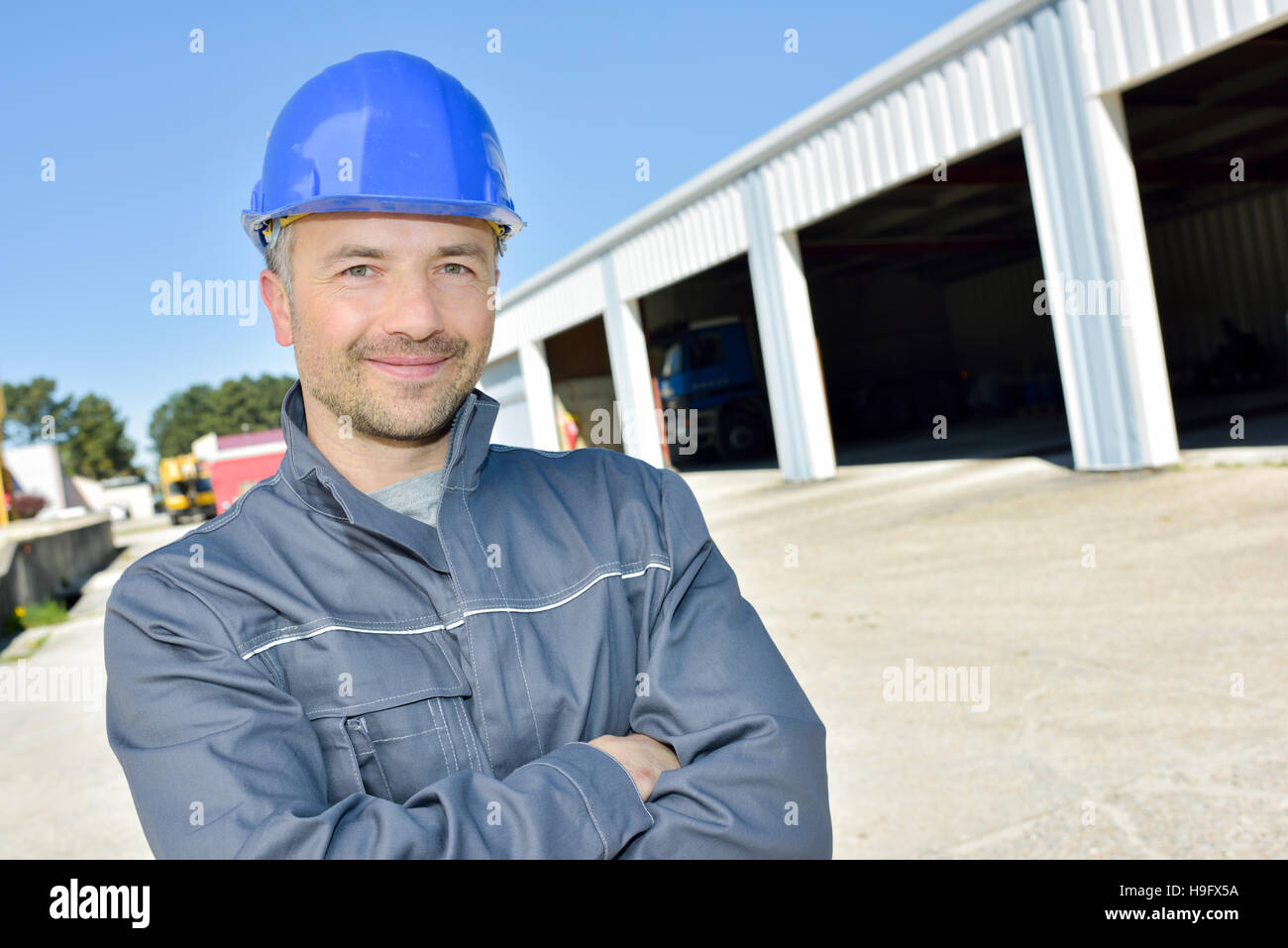 happy construction worker on building site Stock Photo - Alamy