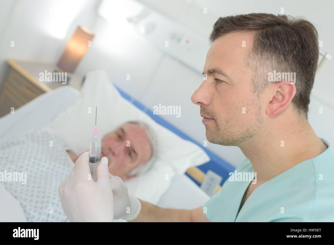 Old Practice Injection doctor giving an injection to a mature patient Stock Photo - Alamy