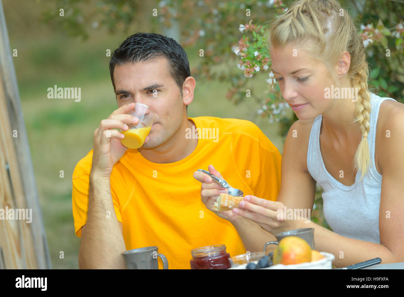 happy couple or friends having breakfast outside Stock Photo - Alamy