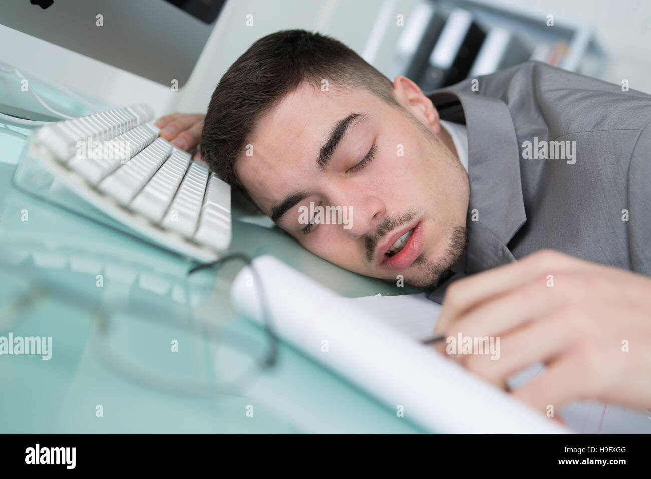 man tried from working and sleeping on working desk Stock Photo - Alamy