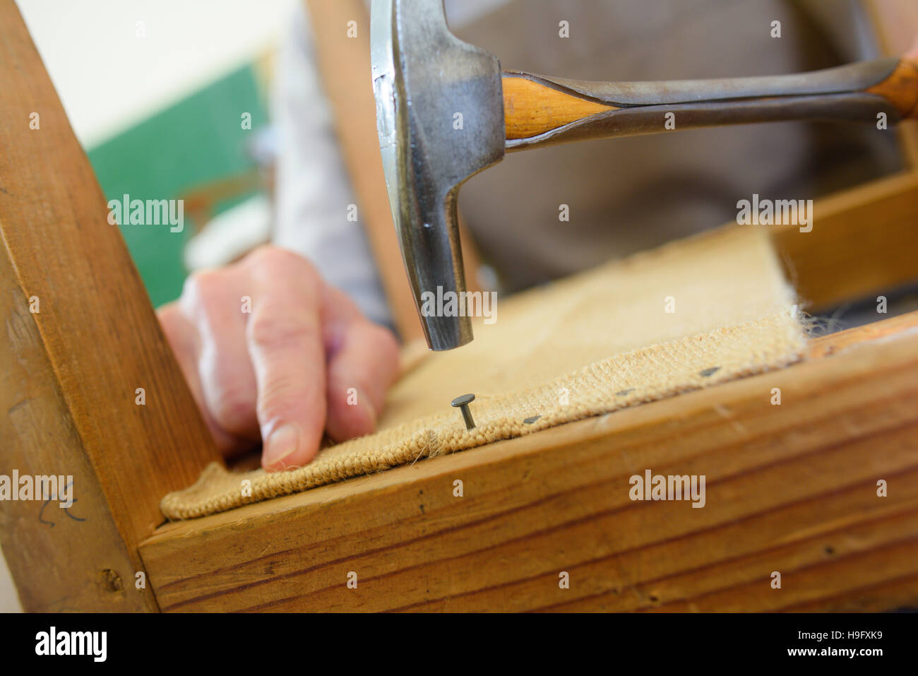 hammer and tack on wood background Stock Photo Alamy