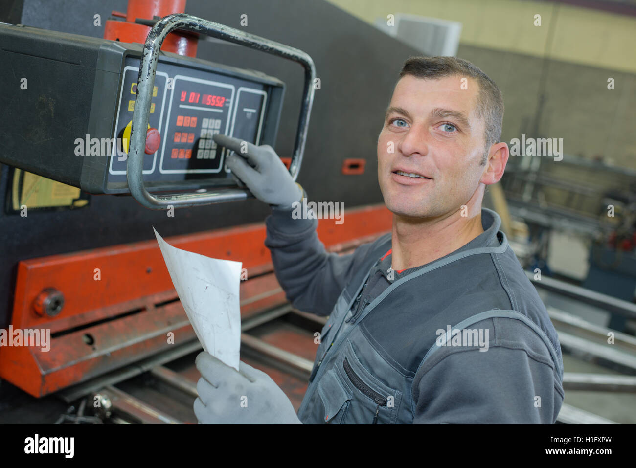 technicien using a electronic device in factory Stock Photo