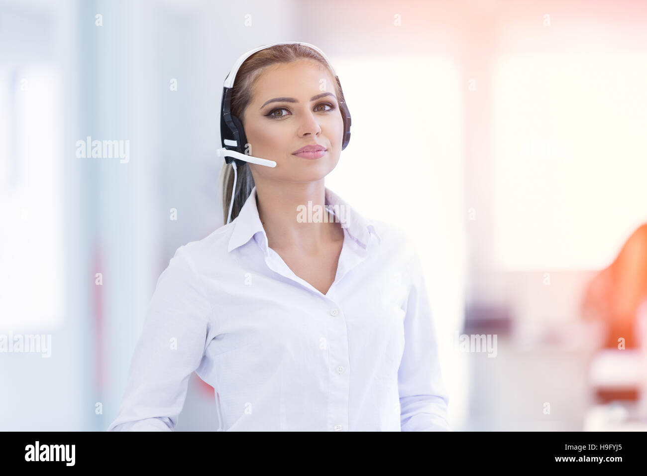 Female customer support operator with headset and smiling Stock Photo Alamy