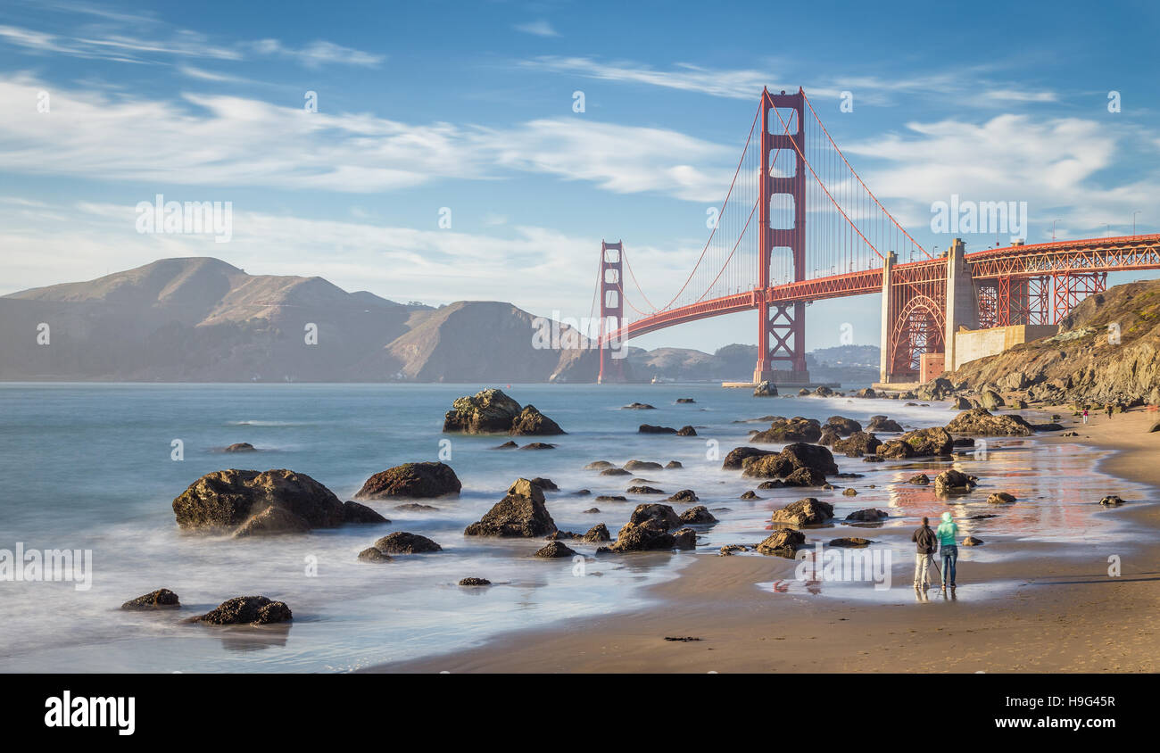 Classic panoramic view of world famous Golden Gate Bridge at sunset seen from Baker Beach, San Francisco, California, USA Stock Photo