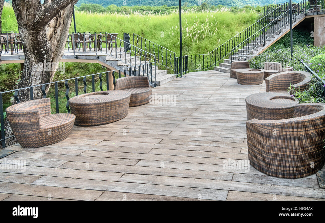 The wood table on natural outdoor of a restaurant with tree and cloudy