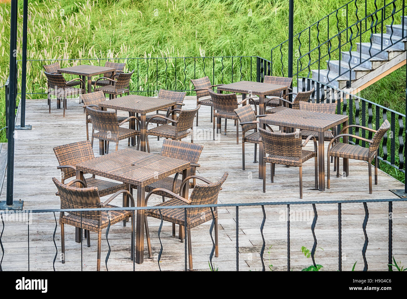 The wood table on natural outdoor of a restaurant with tree and cloudy