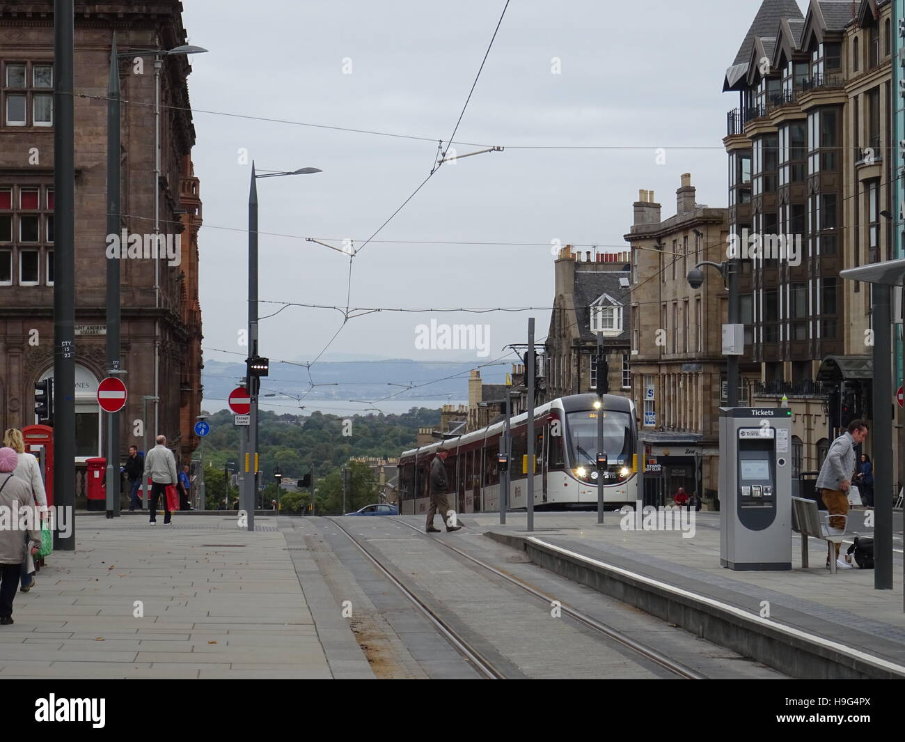 Tram coming up hill in Edinburgh Stock Photo
